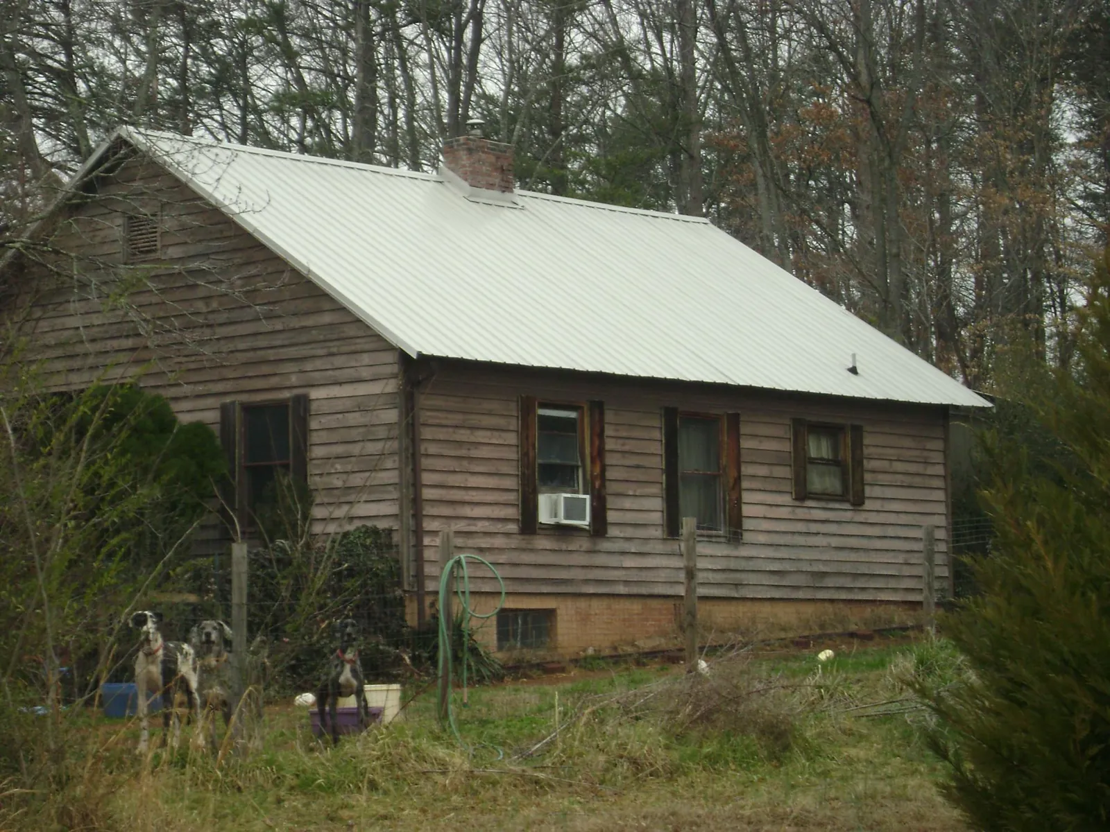 White metal roof on an old wood sided farmhouse, from a Metal Roof Installation job in Powell